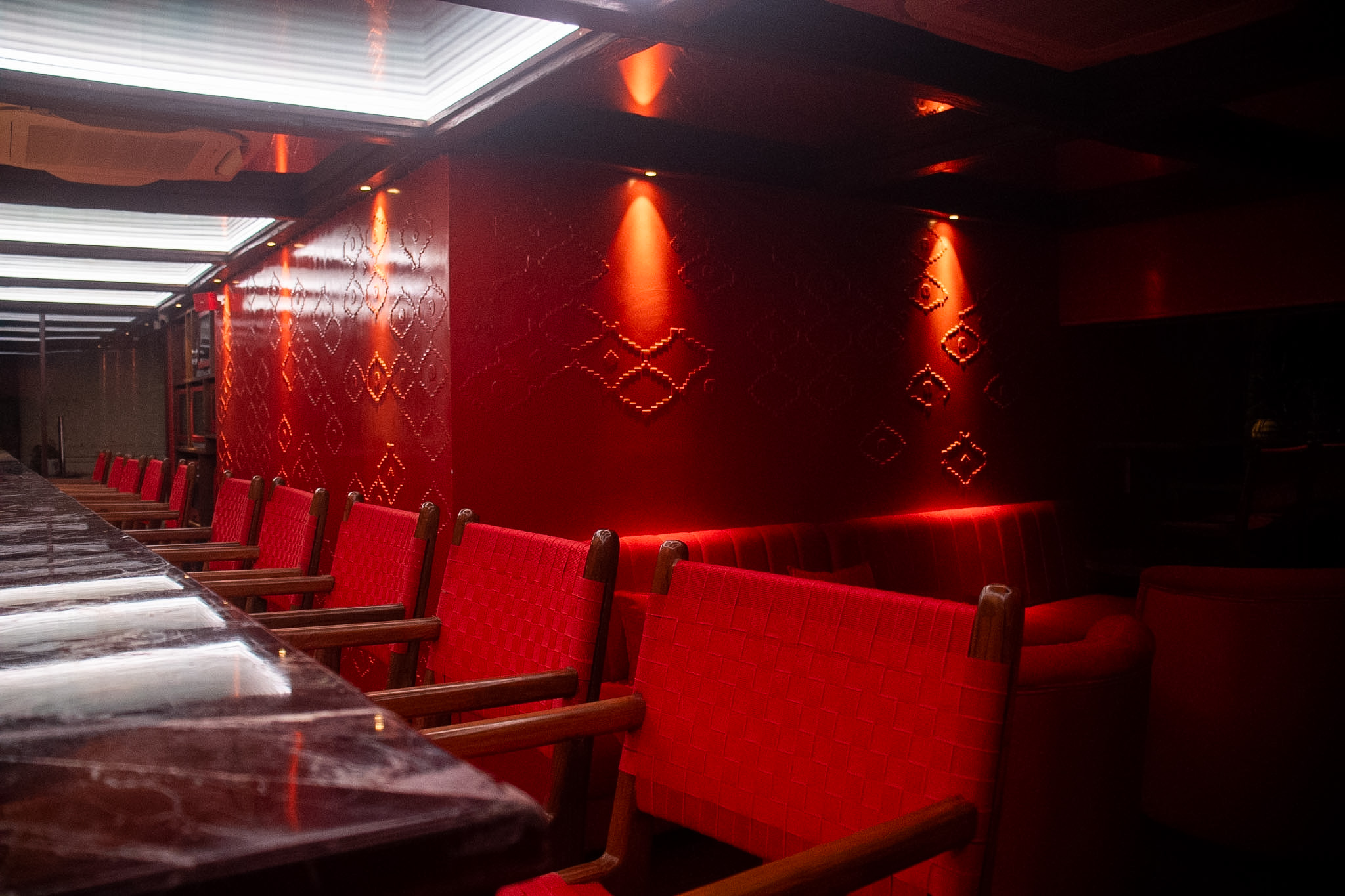 Moody cocktail bar with amber backlight and craft drinks