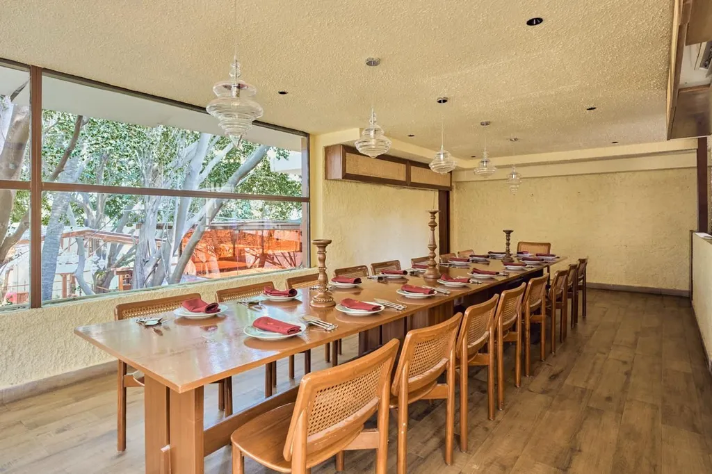 Intimate private dining room with open kitchen and warm candlelight