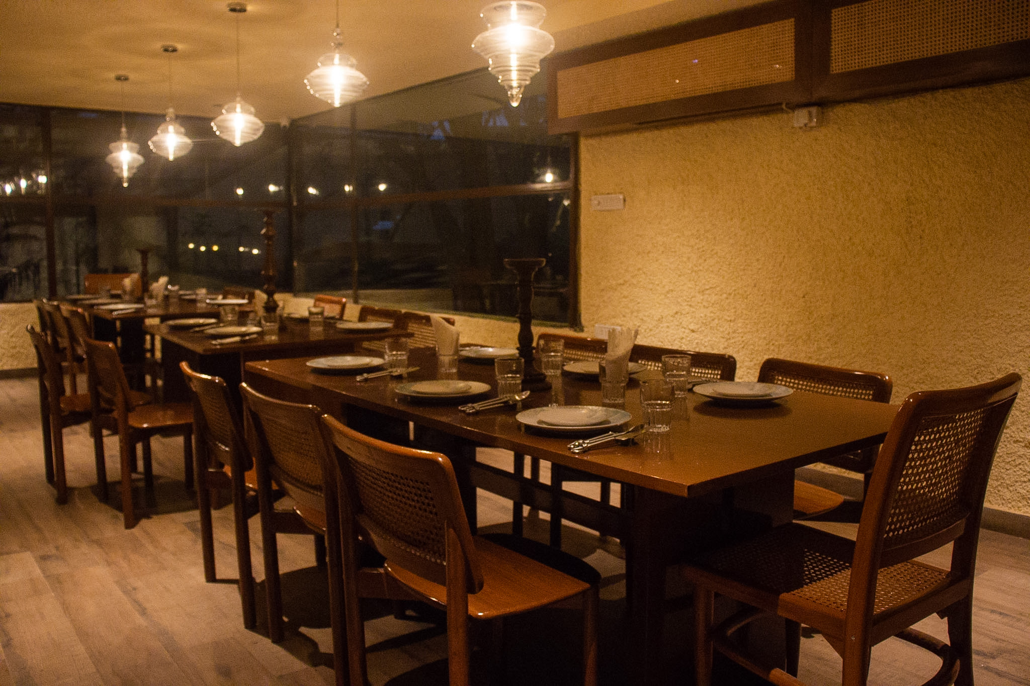 Intimate private dining room with open kitchen and warm candlelight